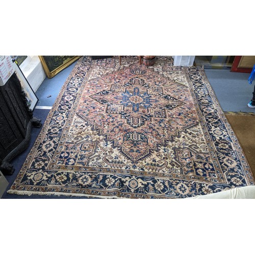 306 - A Persian handwoven rug having a central motif and geometric designs 333cm x 250cm Location:FOYER
If... 