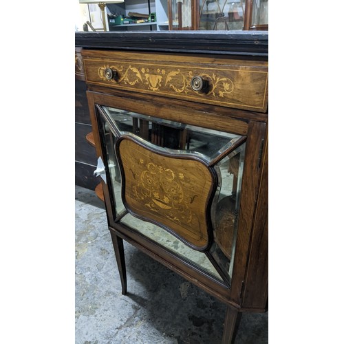 307 - A late Victorian walnut cabinet having marquetry inlaid open shelves, single drawer and a mirrored c... 