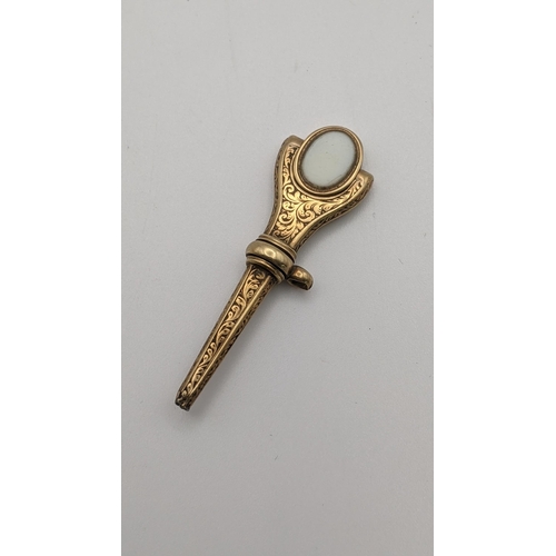 167 - A gold 19th century engraved pocket watch key with the terminal having a swivel for set with two sem... 