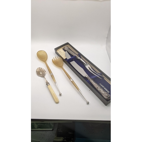 189 - A pair of horn and silver salad servers, silver handled carving set and a jam spoon
Location: 7.2

I... 