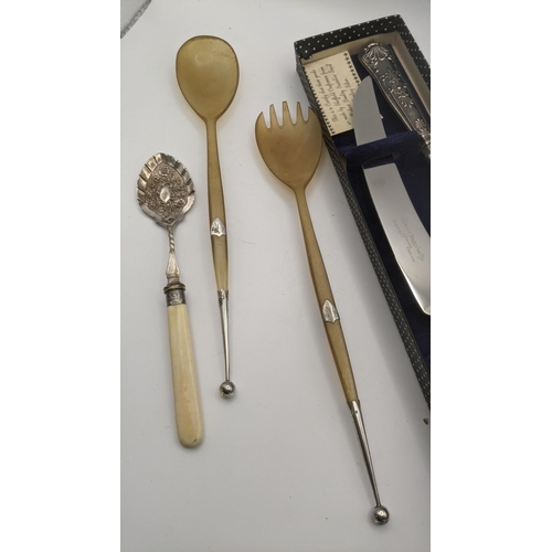 189 - A pair of horn and silver salad servers, silver handled carving set and a jam spoon
Location: 7.2

I... 