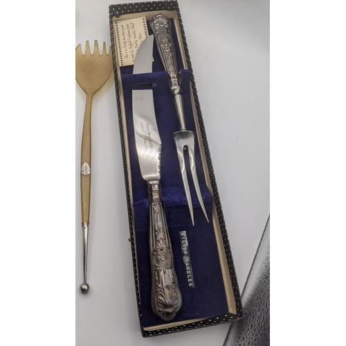 189 - A pair of horn and silver salad servers, silver handled carving set and a jam spoon
Location: 7.2

I... 