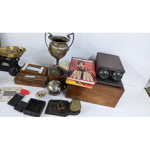 237 - A mixed lot to include weighing scales, silver plated trophies, telephone bell, two boxed sets of bo... 