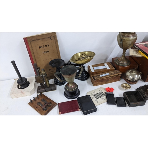 237 - A mixed lot to include weighing scales, silver plated trophies, telephone bell, two boxed sets of bo... 