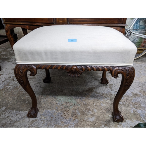 261 - An early 20th century carved walnut upholstered stool, white fabric seat on carved cabriole legs and... 