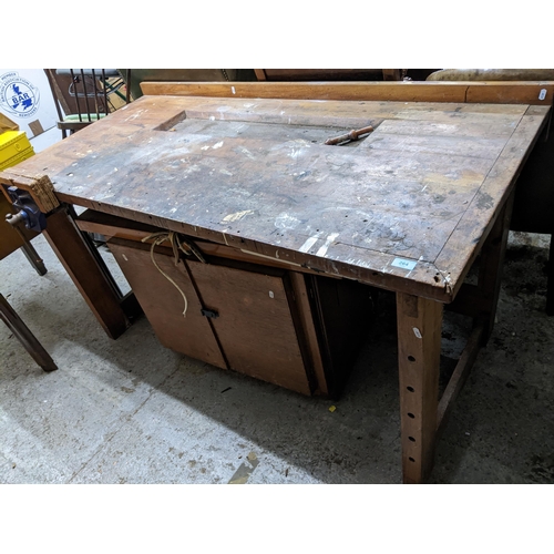 264 - A mid century teak work bench with attached vice and cupboard underneath 89x157.5x77cms
Location: G
... 