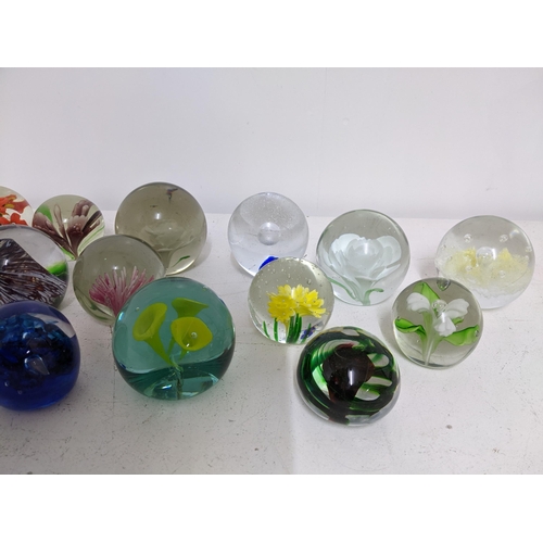 268 - A selection of glass paperweights to include two signed Adam Jablonski abstract weights, a Whitefria... 