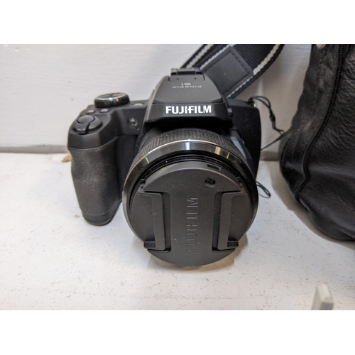 327 - Digital photography equipment and accessories to include an Olympus E-500, a Fujifilm Finepix S1, tw... 