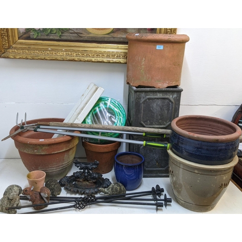 331 - Garden related items to include pots, garden ornaments, a boot scraper, an unused hose, wooden stake... 