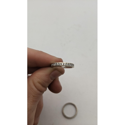 150 - A 14ct white gold half eternity ring set with diamonds, 2g, and a white metal full eternity ring set... 