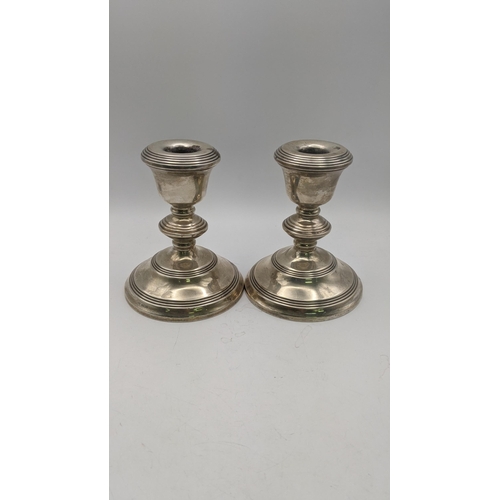 141 - A pair of silver WI Broadway and Co weighted candlesticks hallmarked Birmingham 1965 Location:9.3
If... 