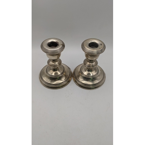 141 - A pair of silver WI Broadway and Co weighted candlesticks hallmarked Birmingham 1965 Location:9.3
If... 