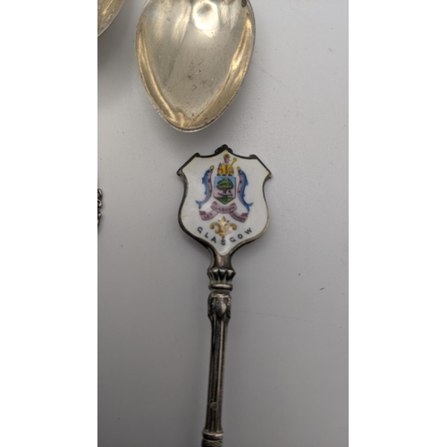 202A - Eleven silver collectors tea spoons, some with twisted terminals and decorated with enamel, to inclu... 