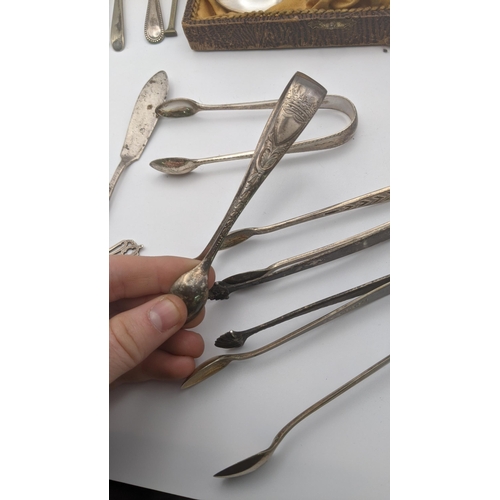 204A - Silver and white metal sugar tongs, 122.4g, together with a pair of silver plated tongs and mixed cu... 