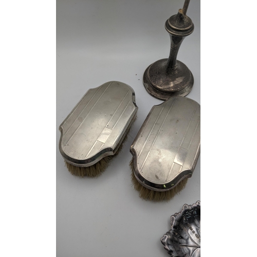 216 - Silver to include two dressing table brushes with engine turned design, a silver rimmed pot, a pin d... 