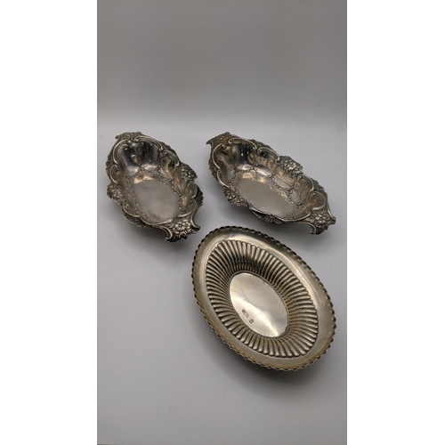 219 - Two white metal embossed floral dishes, together with a silver dish, total weight 205.9g
Location: R... 