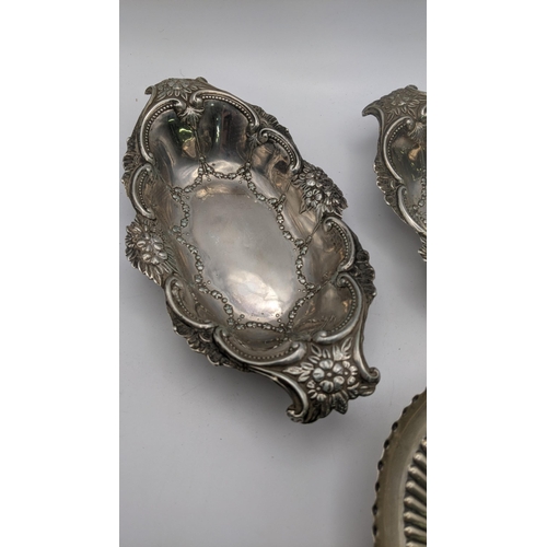 219 - Two white metal embossed floral dishes, together with a silver dish, total weight 205.9g
Location: R... 