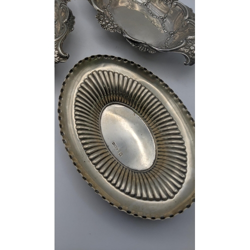 219 - Two white metal embossed floral dishes, together with a silver dish, total weight 205.9g
Location: R... 