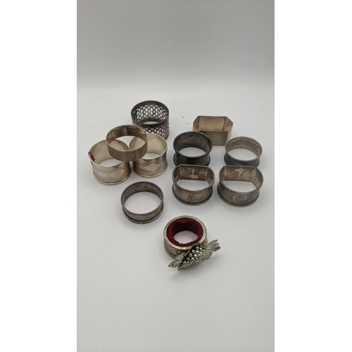 223 - Silver to include an assortment of napkin rings to include a pair of engine turned napkin rings, hal... 