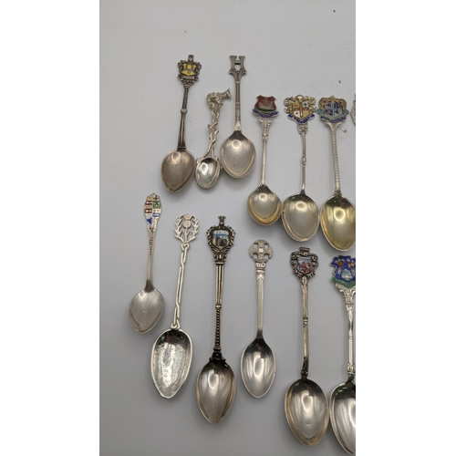 227 - A collection of silver and white metal collectors spoons to include silver spoons decorated with ena... 