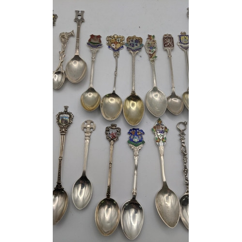 227 - A collection of silver and white metal collectors spoons to include silver spoons decorated with ena... 