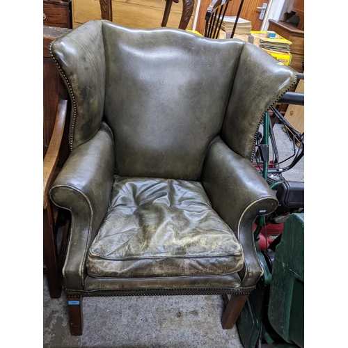 296 - A reproduction green leather upholstered armchair on mahogany square legs and stretchers Location: G... 