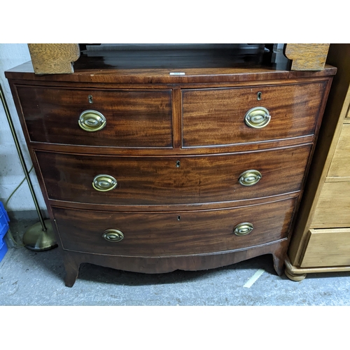 298 - An early 19th century bow fronted mahogany chest of two short and two long graduated drawers, shaped... 