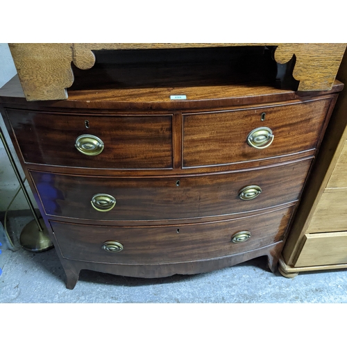 298 - An early 19th century bow fronted mahogany chest of two short and two long graduated drawers, shaped... 