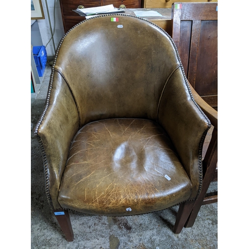 299 - A 20th century faded green/brown leather upholstered tub style chair on mahogany square tapering fro... 