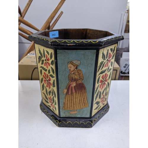 342 - An early 20th century octagonal planter with decorated repeating panels of gentleman in Asian dress ... 