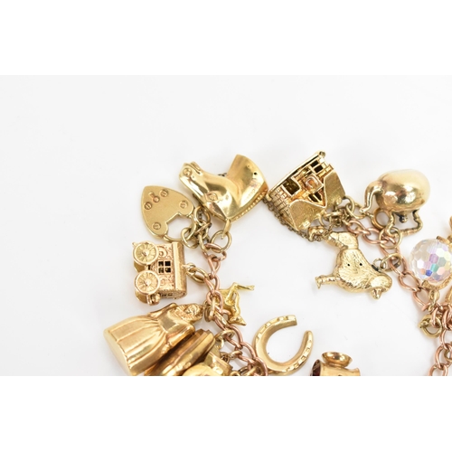 293 - A 9ct yellow gold chain link charm bracelet, with various 9ct gold charms including a matador, fish,... 