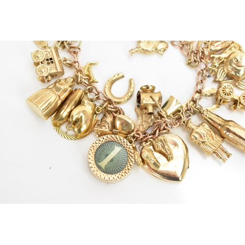 293 - A 9ct yellow gold chain link charm bracelet, with various 9ct gold charms including a matador, fish,... 