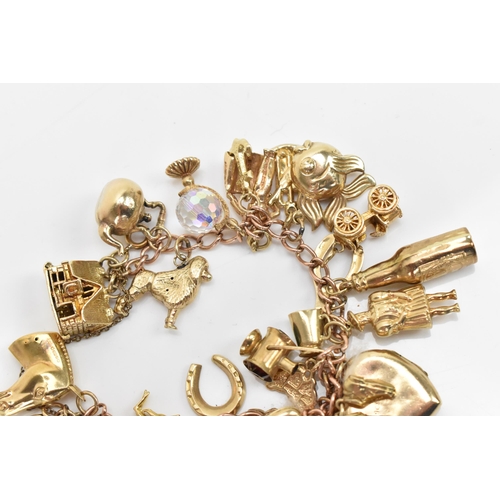 293 - A 9ct yellow gold chain link charm bracelet, with various 9ct gold charms including a matador, fish,... 