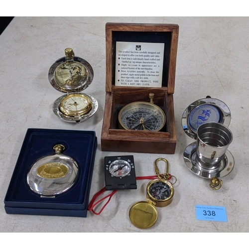 338 - Three compasses, one boxed, the Dalvey Voyager clock in a case, a collapsible pocket dram cup in a c... 