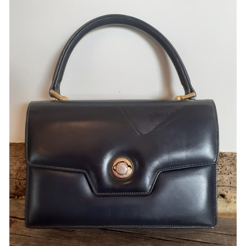 13 - Gucci-A 1960's navy 'Lady Lock' top handle handbag with gold tone hardware and matched purse with re... 