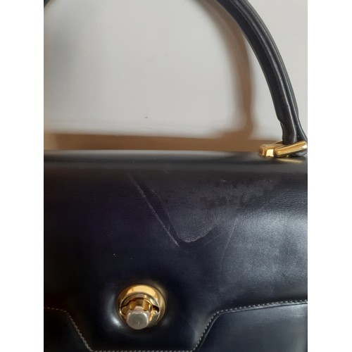 13 - Gucci-A 1960's navy 'Lady Lock' top handle handbag with gold tone hardware and matched purse with re... 