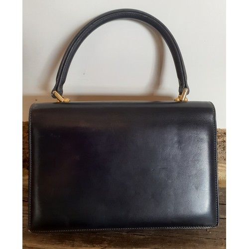 13 - Gucci-A 1960's navy 'Lady Lock' top handle handbag with gold tone hardware and matched purse with re... 