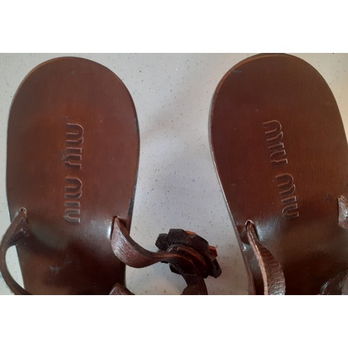 36 - Miu Miu- A pair of brown Vero Cuoio 'Bufalo Flow Coco-Manda' heeled sandals with brown and orange fl... 