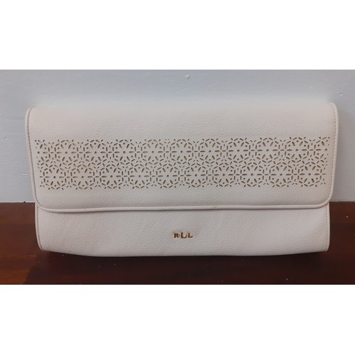 21 - Ralph Lauren-An unused cream clutch with cut-out design to the fold over flap, initials RLL in gold ... 