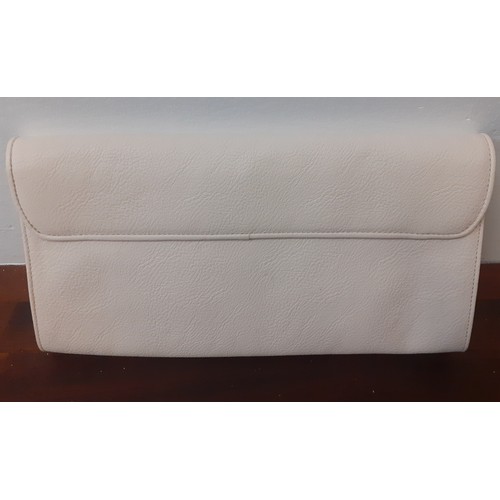 21 - Ralph Lauren-An unused cream clutch with cut-out design to the fold over flap, initials RLL in gold ... 