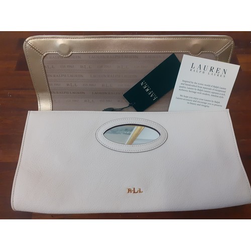 21 - Ralph Lauren-An unused cream clutch with cut-out design to the fold over flap, initials RLL in gold ... 