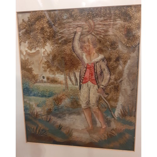 124 - A 19th Century stumpwork embroidery A/F depicting a young boy in bare feet holding a bundle of stick... 