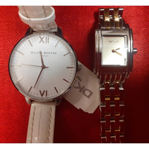 63 - Ladies fashion watches to include an Olivia Burton oversized watch with white leather strap, an unwo... 