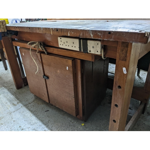 250 - A mid century teak work bench with attached vice and cupboard underneath 89x157.5x77cms
Location: G
... 