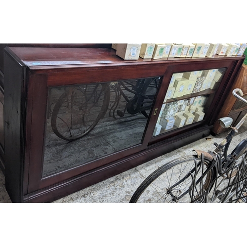 305 - A late Victorian mahogany bookcase, twin glazed sliding doors with inset brass handles, internal adj... 