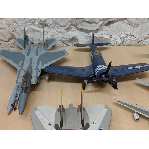 26 - Nine aircrafts - Four military planes to include a Tamiya 1/48 plastic model kit Grumman F-14A Tomca... 