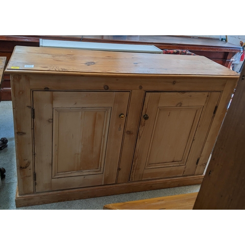 262 - A Victorian pine side cabinet with twin fielded panelled doors on plinth base 100cm x 153cm x 48.5cm... 