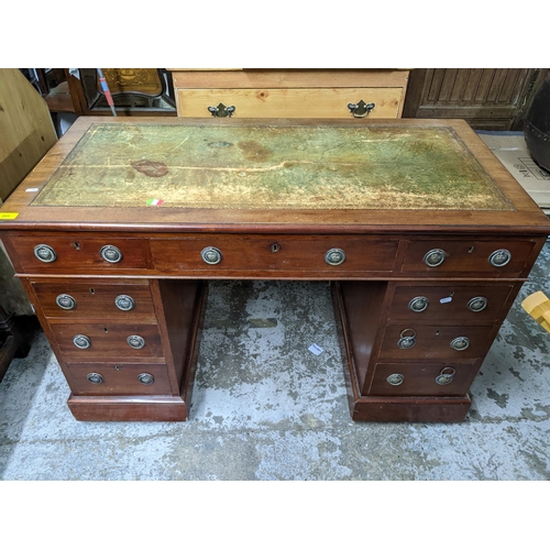 268 - An Edwardian mahogany twin pedestal desk with a green leather scriber over one long flanked by two s... 