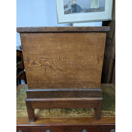 276 - A 19th century oak square form chest on later stand, hinged top, twin brass carrying handles, the st... 