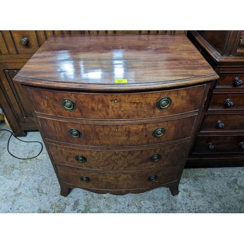 284 - An early 20th century mahogany bow fronted chest of four long drawers, shaped apron, on bracket feet... 